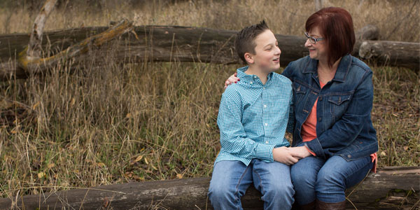 Mother and son sitting outside