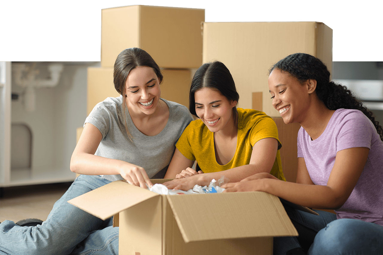 A group of girls opening moving boxes - Independent Living